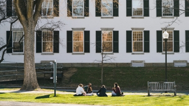 Students sitting outside of Reed Hall.